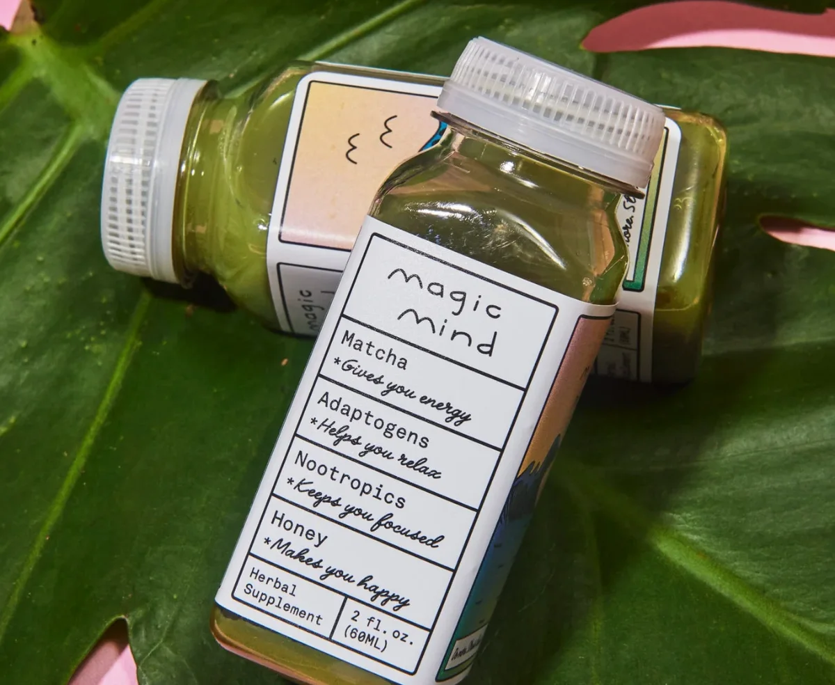 Custom printed bottle label resting on a green leaf